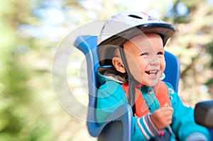 Little boy in bike child seat happy