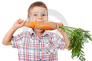 Little boy biting the carrot