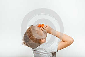 Little boy biting the carrot, isolated on white