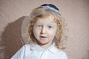 The little boy with blond curls in Jewish skullcap