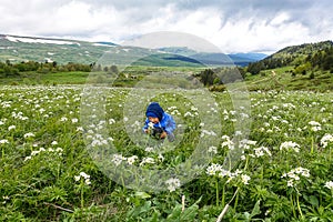 A little boy on the blooming alpine meadows of Lago-Naki. Adygea. Russia 2021