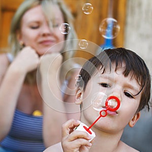 Little boy blow soap bubbles