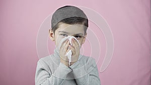 Little boy blowing nose. Sick coughing child sneezing