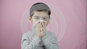 Little boy blowing nose. Sick coughing child sneezing
