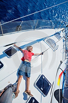 Little boy on board of sailing yacht on summer cruise. Travel adventure, yachting with child on family vacation.