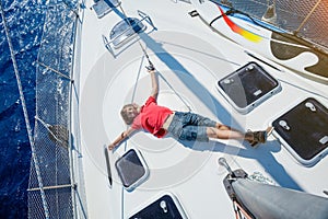 Little boy on board of sailing yacht on summer cruise. Travel adventure, yachting with child on family vacation.