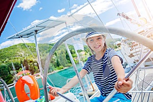 Little boy on board of sailing yacht on summer cruise. Travel adventure, yachting with child on family vacation.