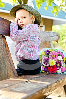 Little boy with a bouquet of flowers