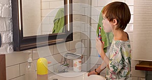 Little boy brushing his teeth with an electric brush