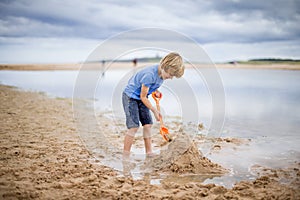 Little boy building sand castle