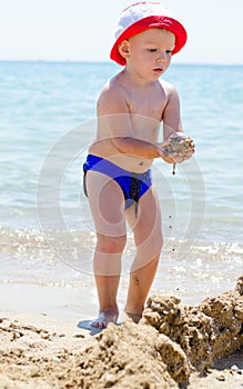 Little boy building sand castles