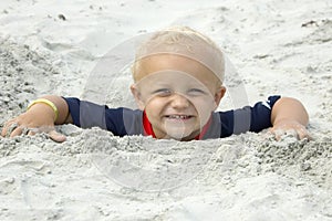 Little Boy Buried in Sand up to Head