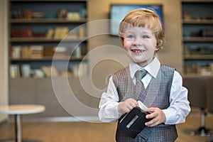 Little boy in business clothes with a puncher in photo
