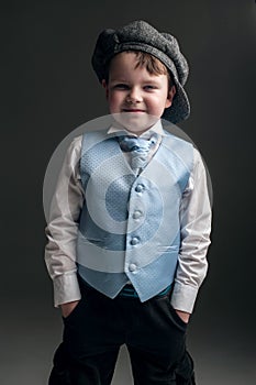Little boy in cap and blue vest