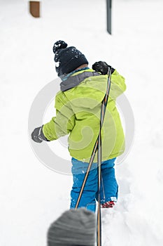 Little Boy is Carrying a Sled