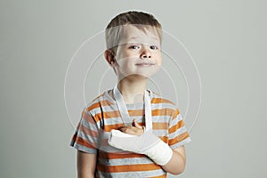 Little boy in a cast.child with a broken arm. funny kid after accident