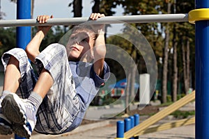 Little boy catch up on the horizontal bar