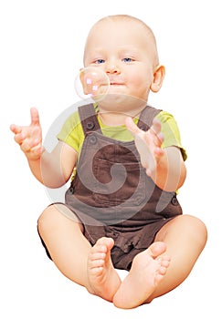Little boy catching soap bubble isolated on white