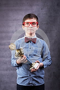 Little boy celebrates his golden trophy