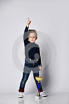 Little boy celebrates his golden trophy