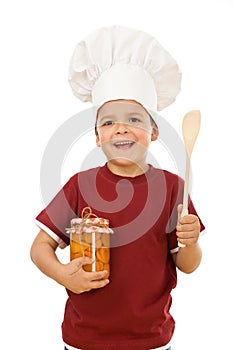 Little boy chef with a jar of canned fruit