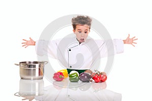 Little boy chef in uniform cooking