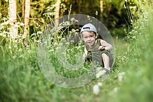 Little boy child caucasian white skin in forest smiling