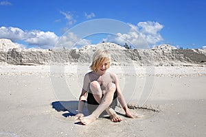 Little Boy Child Playin in the White Sand on the Beach at the Ocean