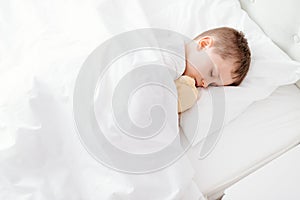 Little boy child sleeping in bed