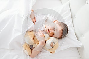 Little boy child sleeping in bed