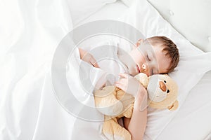 Little boy child sleeping in bed