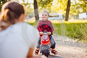 Little boy on a children`s bike in the park