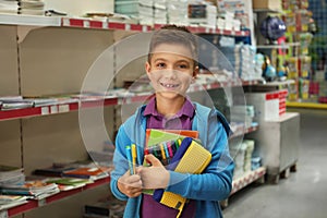 Little boy choosing school stationery