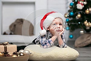 Little boy in Christmas decorations expect a miracle