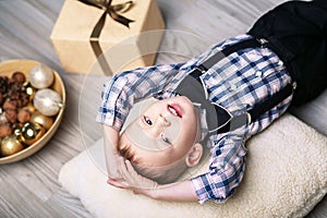 Little boy in Christmas decorations expect a miracle