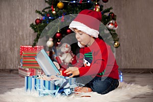 Little boy on christmas, opening presents