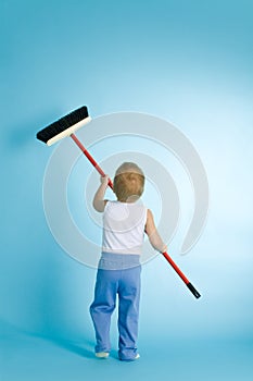 Little boy with cleaning swab over blue photo
