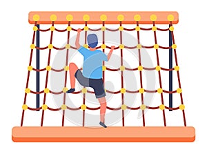 Little boy climbing at rope wall or net wall, sports activity, energy child at sports playground