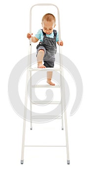Little boy climbing up on ladder