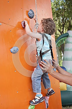 Little boy climbing wall