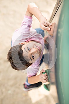 Little boy climping up brave playground