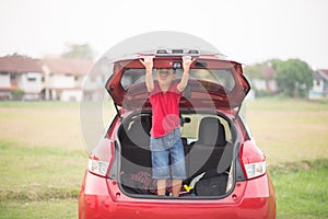 Little boy closing the back door car auto