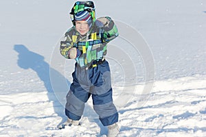 The little boy in a color jacket standing in a combative rack