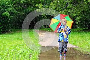 Little boy with colorful umbrella outdoors