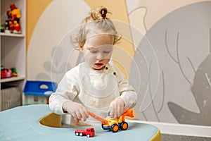 Little Boy Concentrating on Playing with Toys