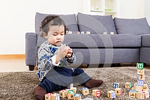 Little boy concentration on playing wooden toy block