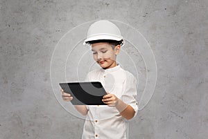 little boy in construction helmet with tablet pc