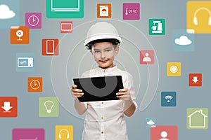 little boy in construction helmet with tablet pc