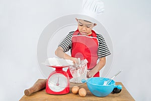 Little boy cooking cake home made bakery