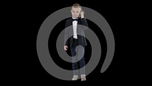 Little boy in a costume making a phone call while walking, Alpha Channel